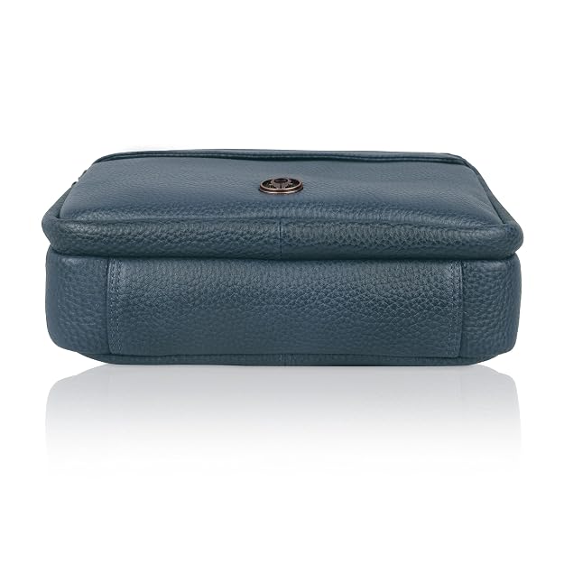 A dark teal blue pebbled leather pouch with a small round metal button closure on the front, shown against a plain white background with a soft reflection below.