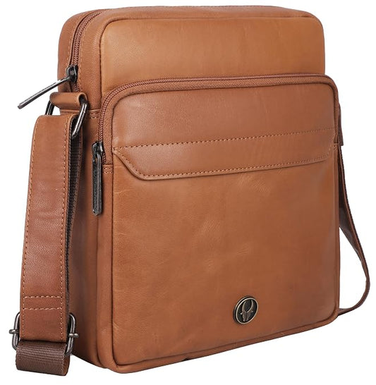A brown leather crossbody bag with a front zippered pocket, side zipper, and adjustable shoulder strap, shown on a plain white background.