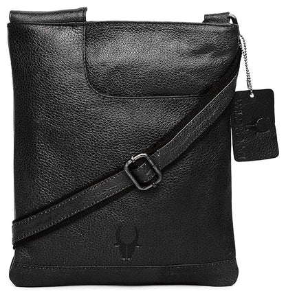 Black textured leather crossbody bag with a diagonal strap, a hanging brand tag, and a debossed logo on the front, shown on a white background.