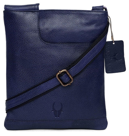 A navy blue textured leather crossbody bag with a matching adjustable strap and a hanging brand tag, shown on a plain white background.