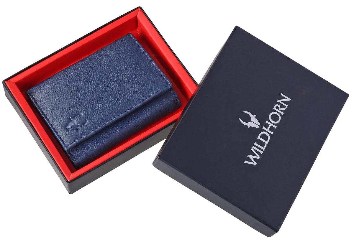 A dark blue textured leather wallet presented in an open black gift box with a red interior, alongside the closed navy blue lid featuring the white WILDHORN logo.