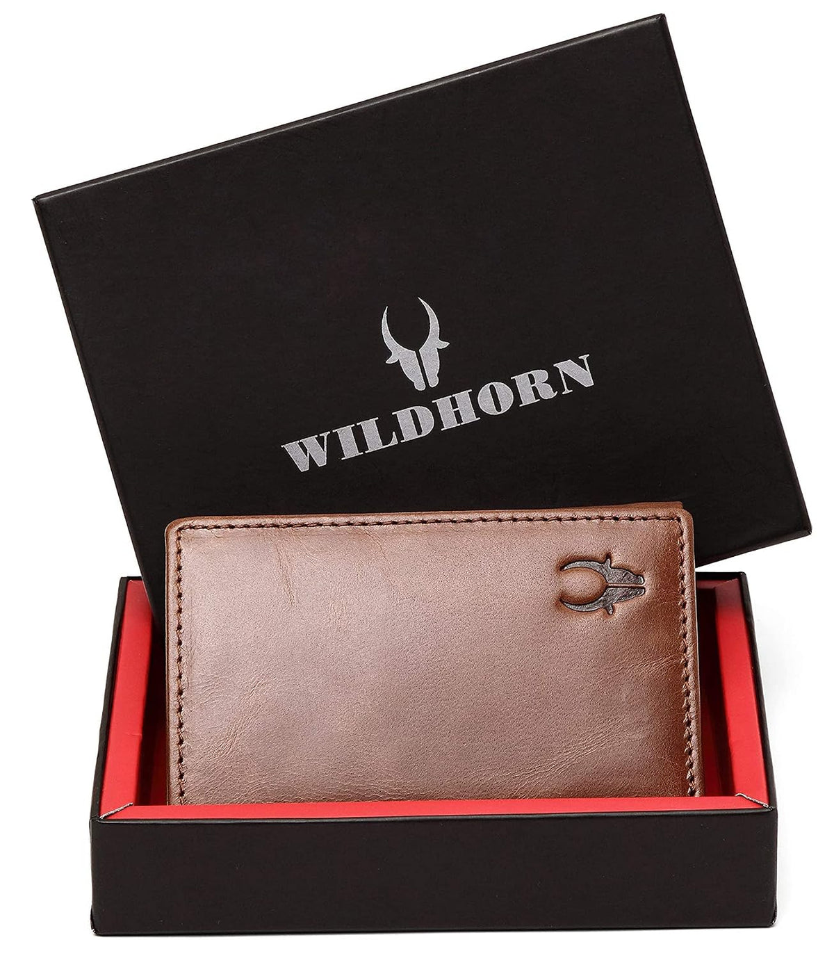 A brown leather wallet displayed in an open black Wildhorn gift box with a red interior. The lid is propped behind the wallet, showing the silver Wildhorn logo and bull head emblem.