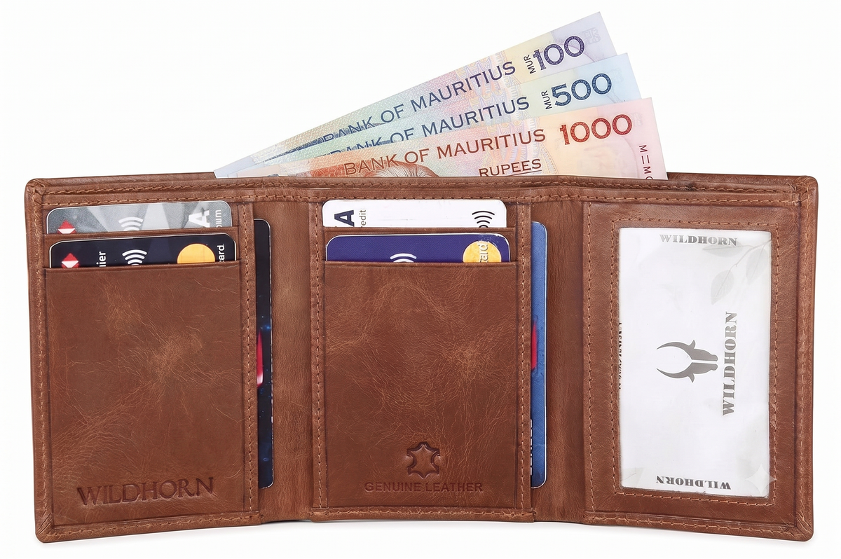 A brown leather bifold wallet shown open on a white background, containing credit cards, cash, and a printed ID card. The wallet has 'WILDHORN' branding embossed on the lower left and center, and a clear ID window on the right. Available in Mauritius.