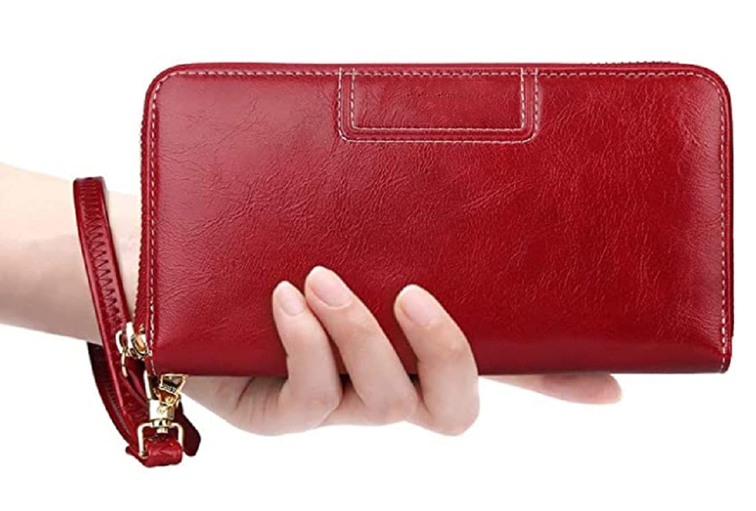 A red Genuine-leather zip-around wallet with a wrist strap and gold-tone hardware, held in a person's hand against a white background Mauritius bags.mu