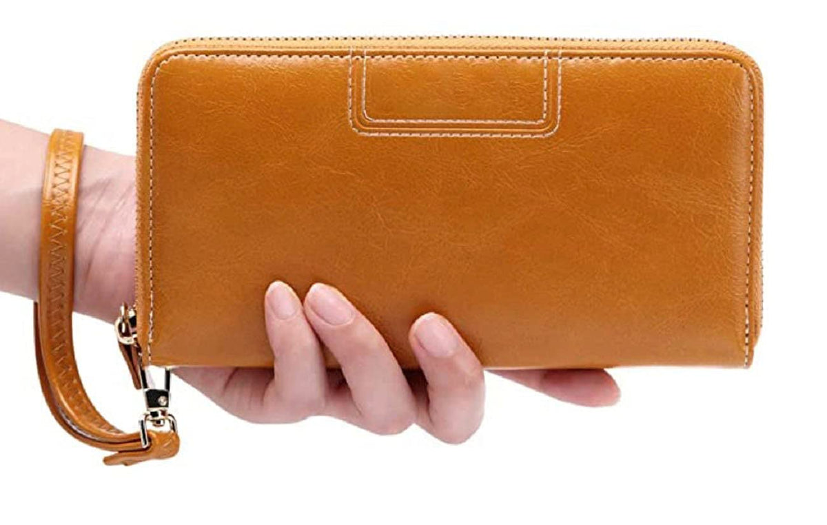 A tan leather zip-around wallet with a wrist strap, held in a person's hand against a plain white background available in Mauritius